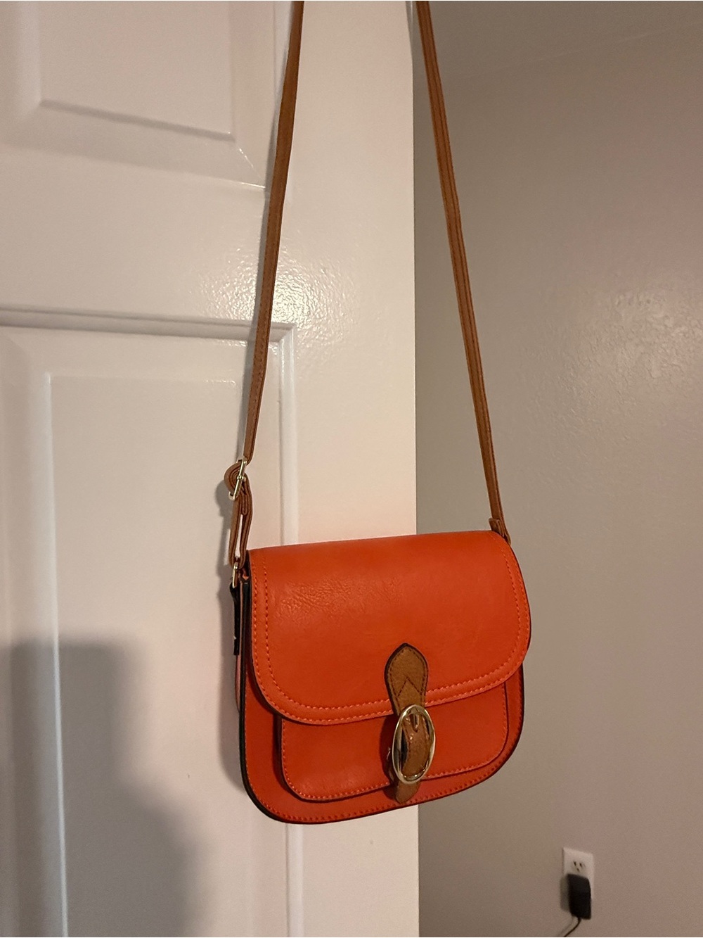 Compact Orange Crossbody Bag with Gold-Tone Buckle and Tan Strap